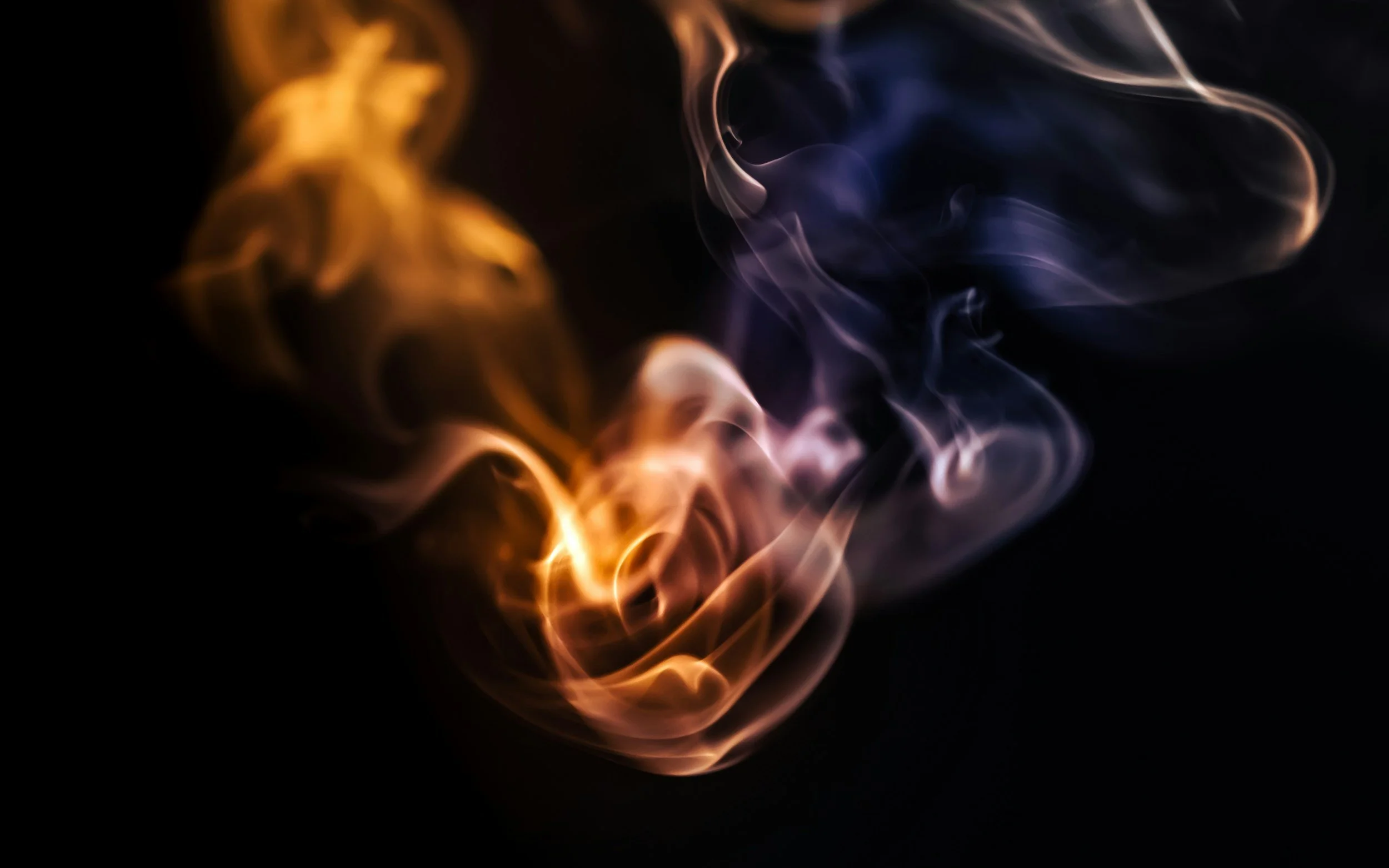 Orange flame and indigo smoke intertwining on a black backdrop — symbolizing the science-and-soul approach to integrative psychiatry at WorthyMind Practice in Tarrytown, NY